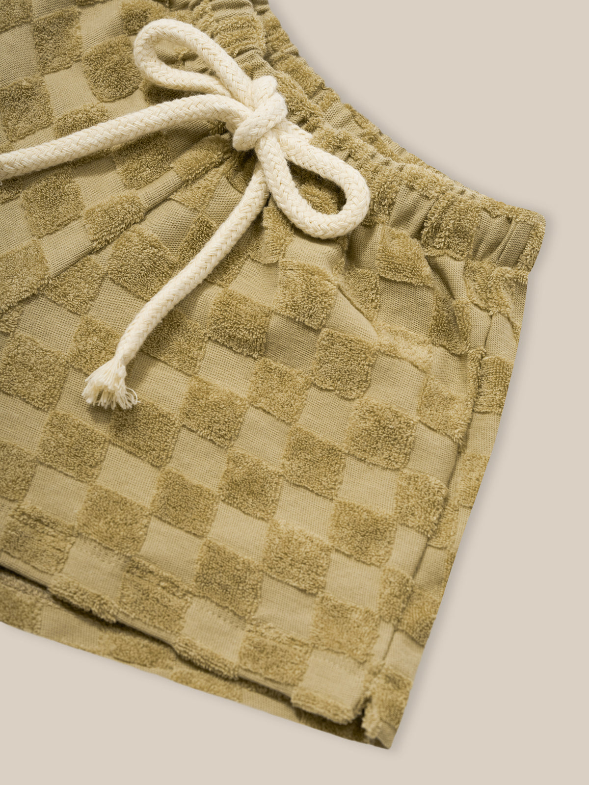 close up of baby & toddler beige checkerboard rope shorts in terry cotton with elastic waistband