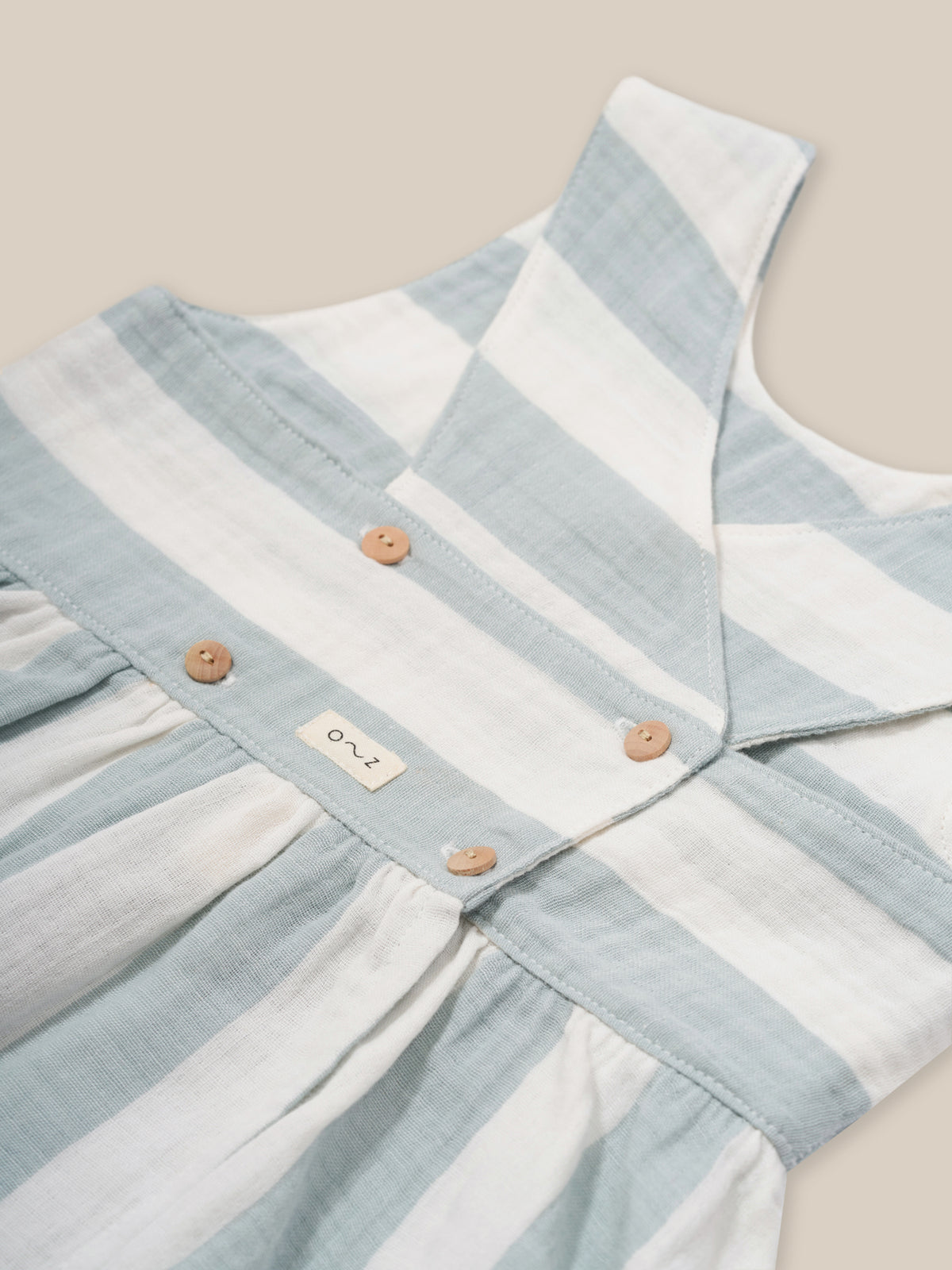 toddler sardine blue striped muslin sleeveless dress with wooden button back and curved hem