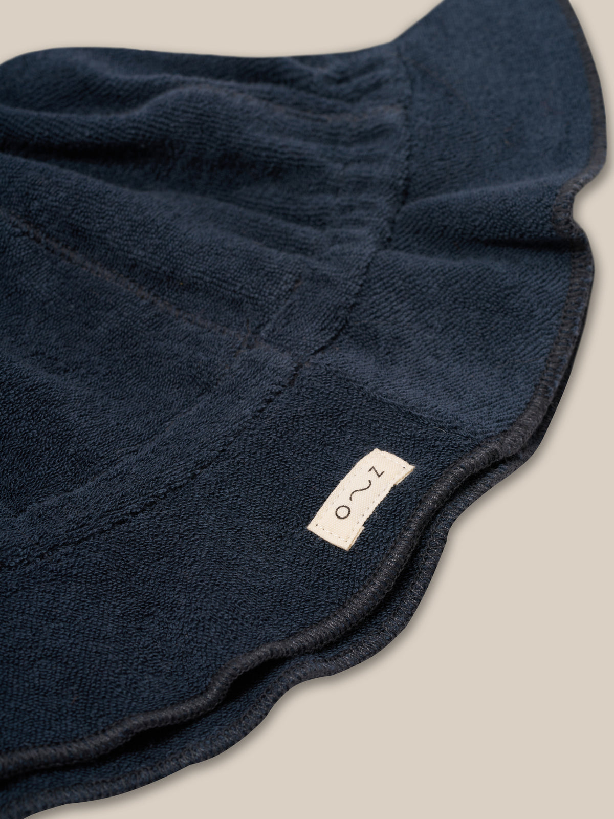 close up of baby & toddler navy sun hat in soft organic terry cotton finished with o~z label