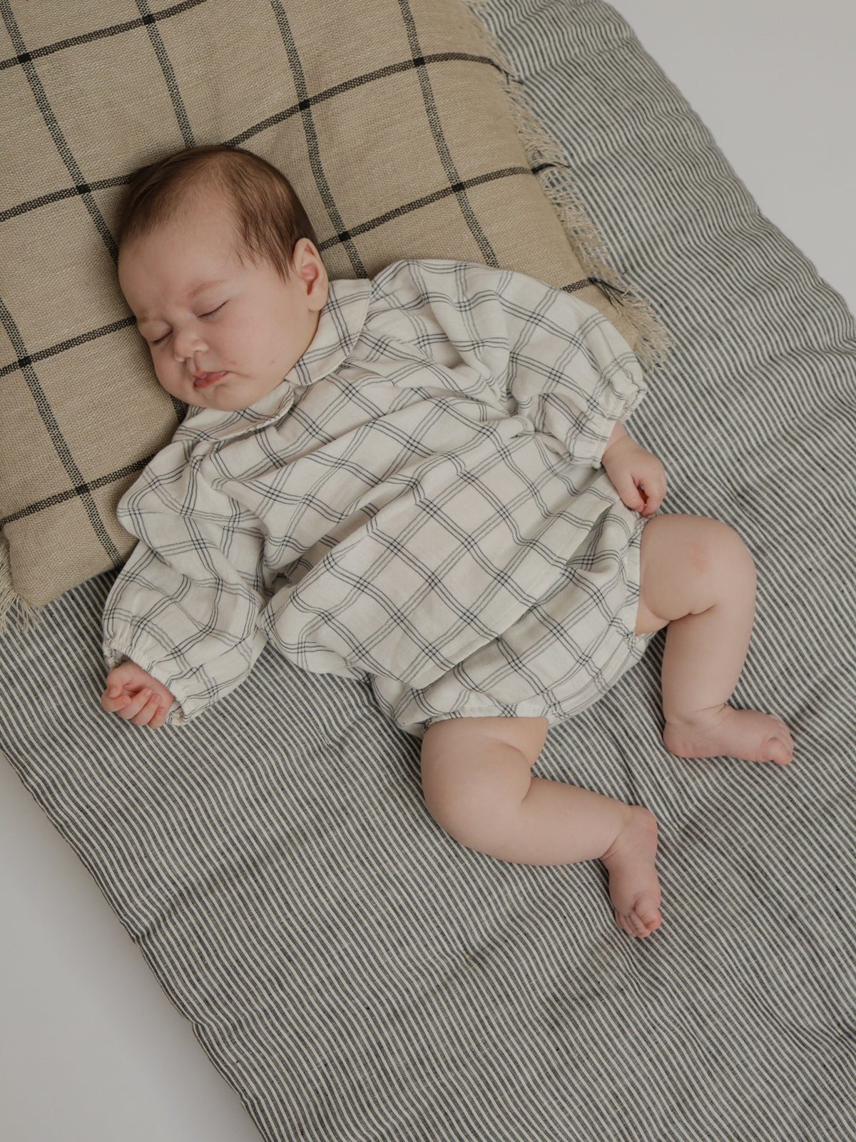 sleeping baby in organic muslin shortie bloomers with navy window check print & matching dress