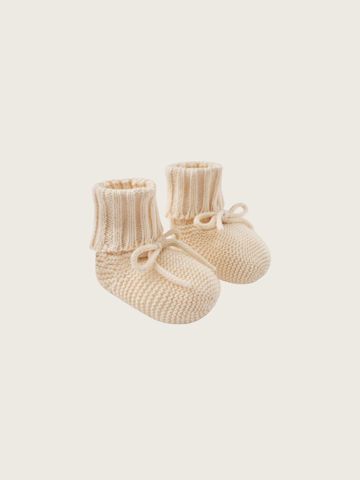baby and toddler undyed cotton knitted booties in cream with ribbons
