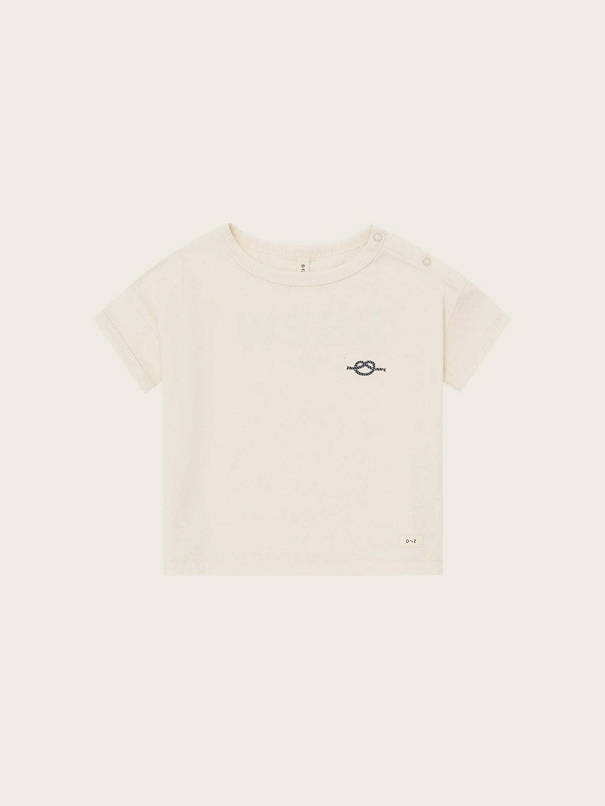 Beige t-shirt with a small logo on a white background