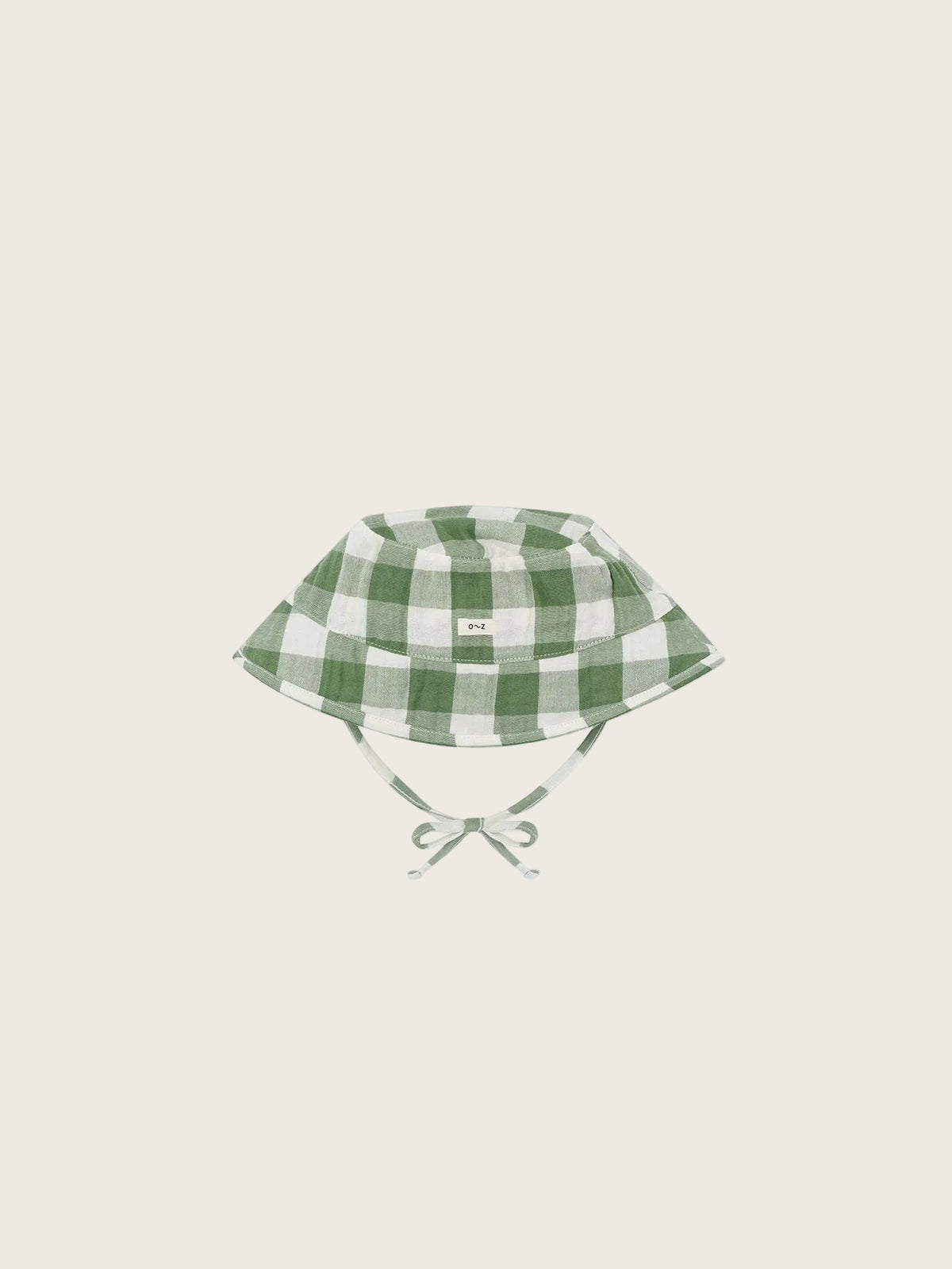 Green and white checkered baby hat on a white background