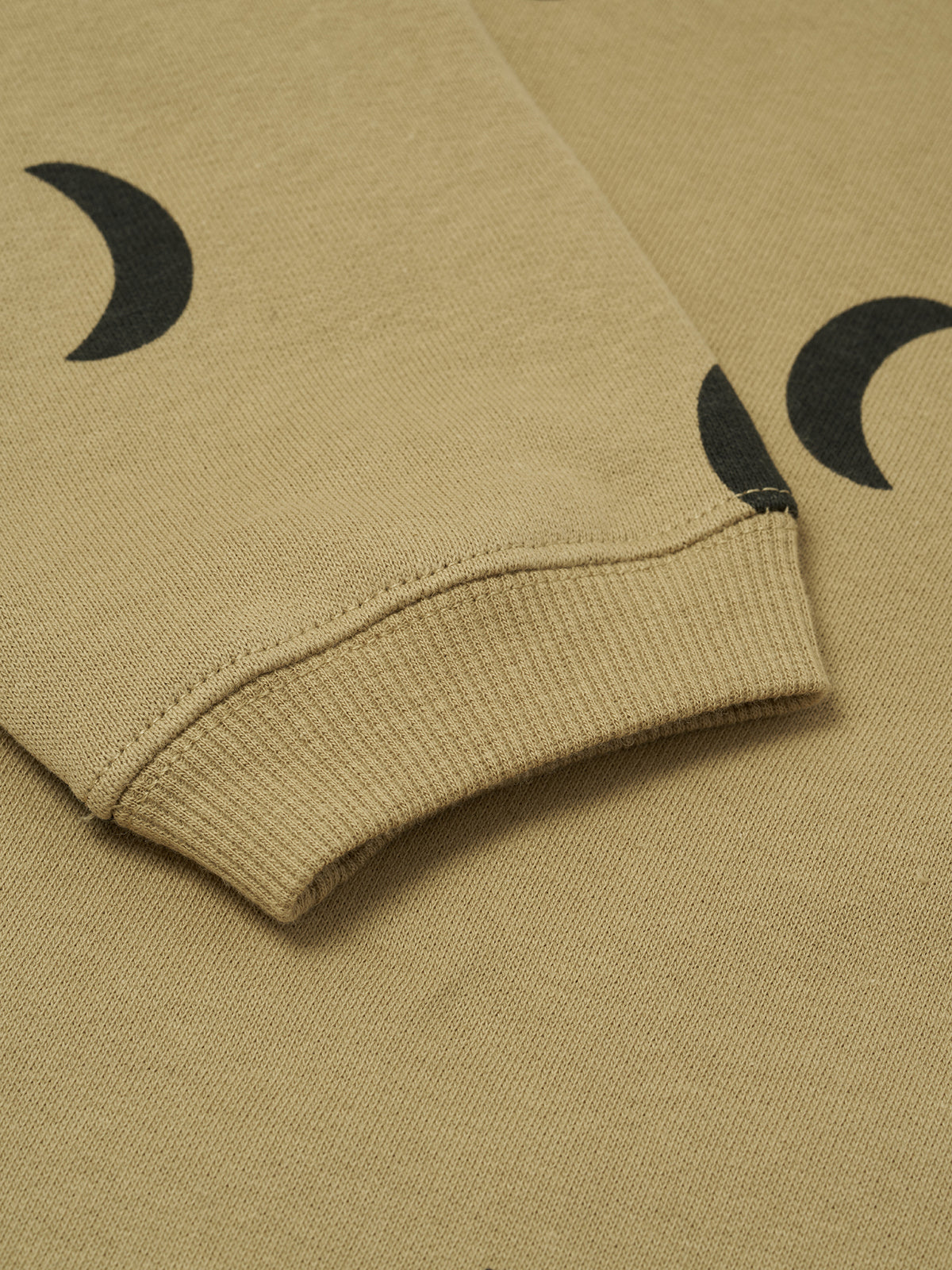 close up of baby and toddler dusky beige organic cotton boxy sweatshirt with black crescent moon print
