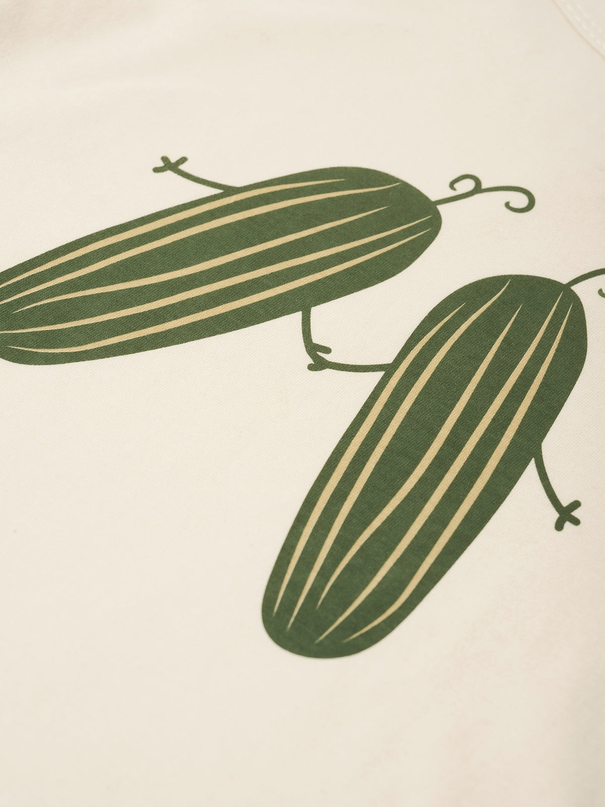 Two green cucumbers on a beige background