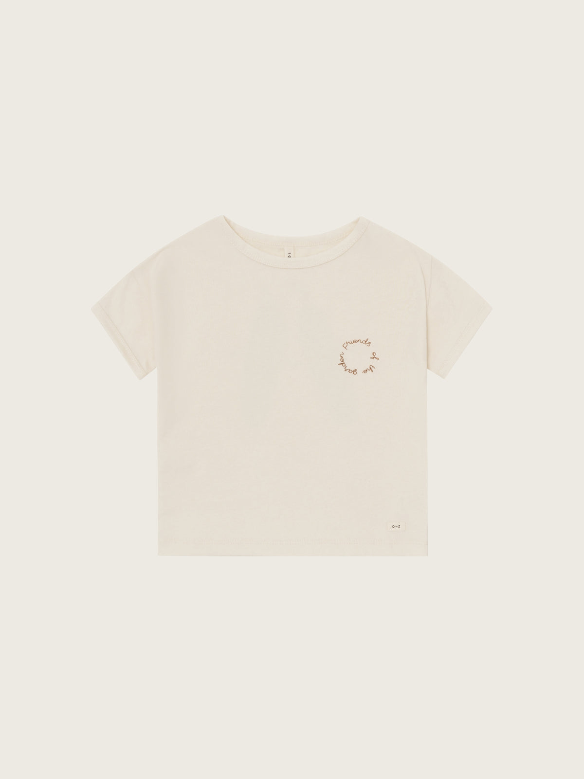 Beige t-shirt with a small graphic on a light beige background