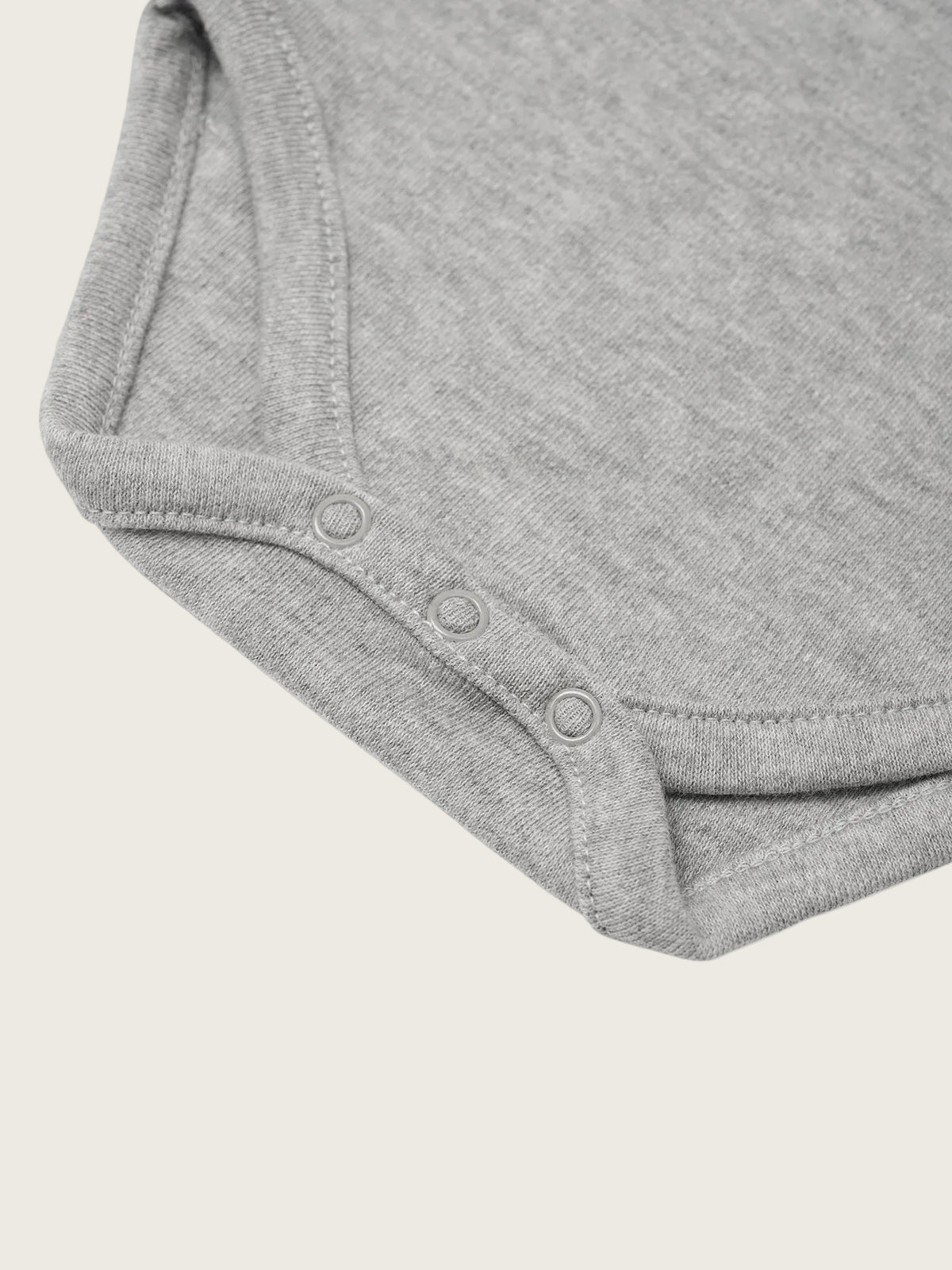 Close-up of a gray baby onesie on a white background