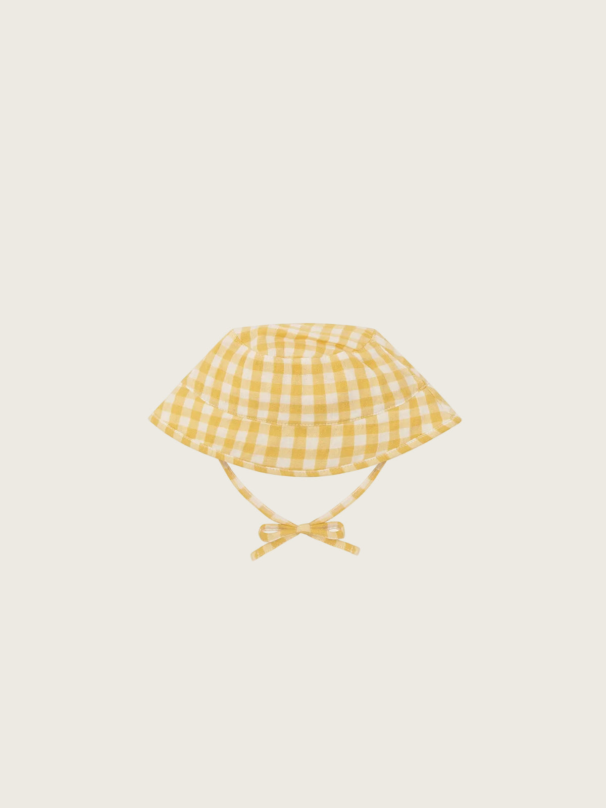 Yellow checkered baby hat with a bow on a white background