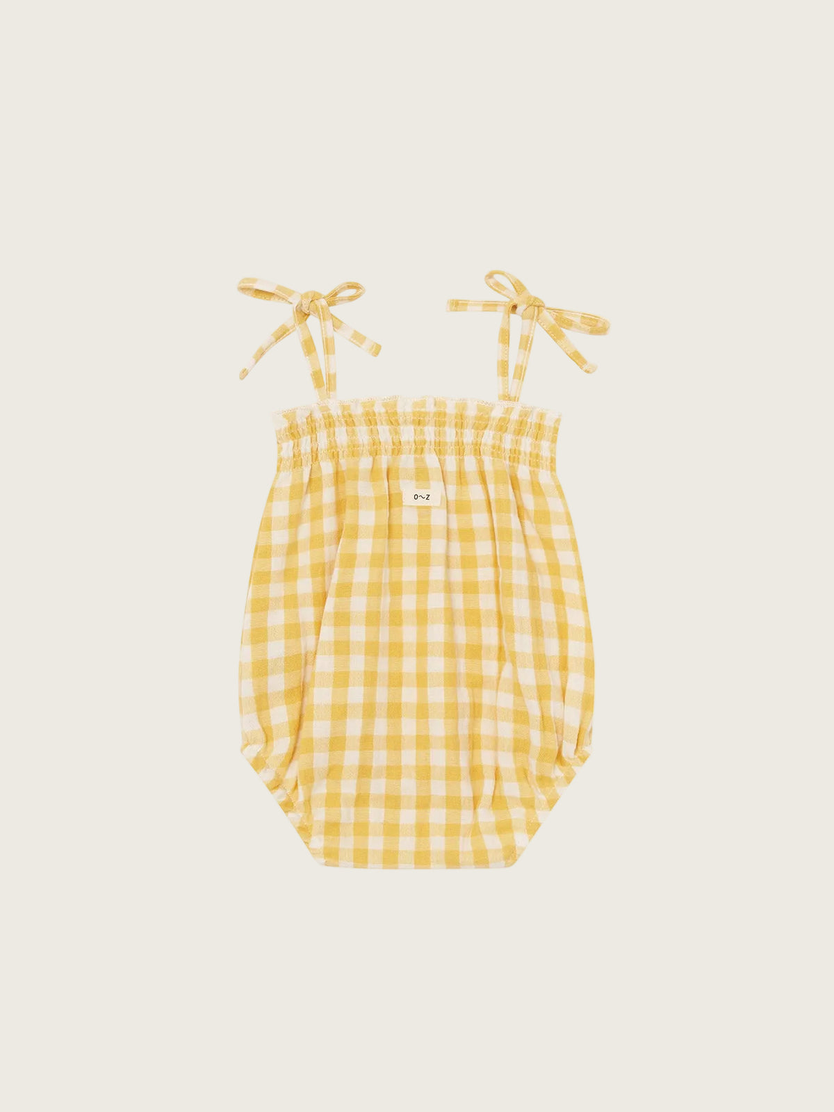 Yellow gingham baby romper with straps on a white background