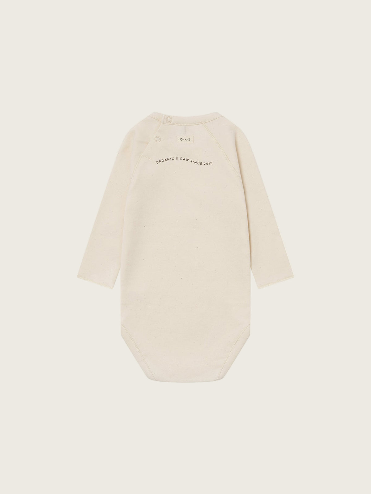 baby cream undyed cotton bodysuit with organic & raw since 2010 slogan