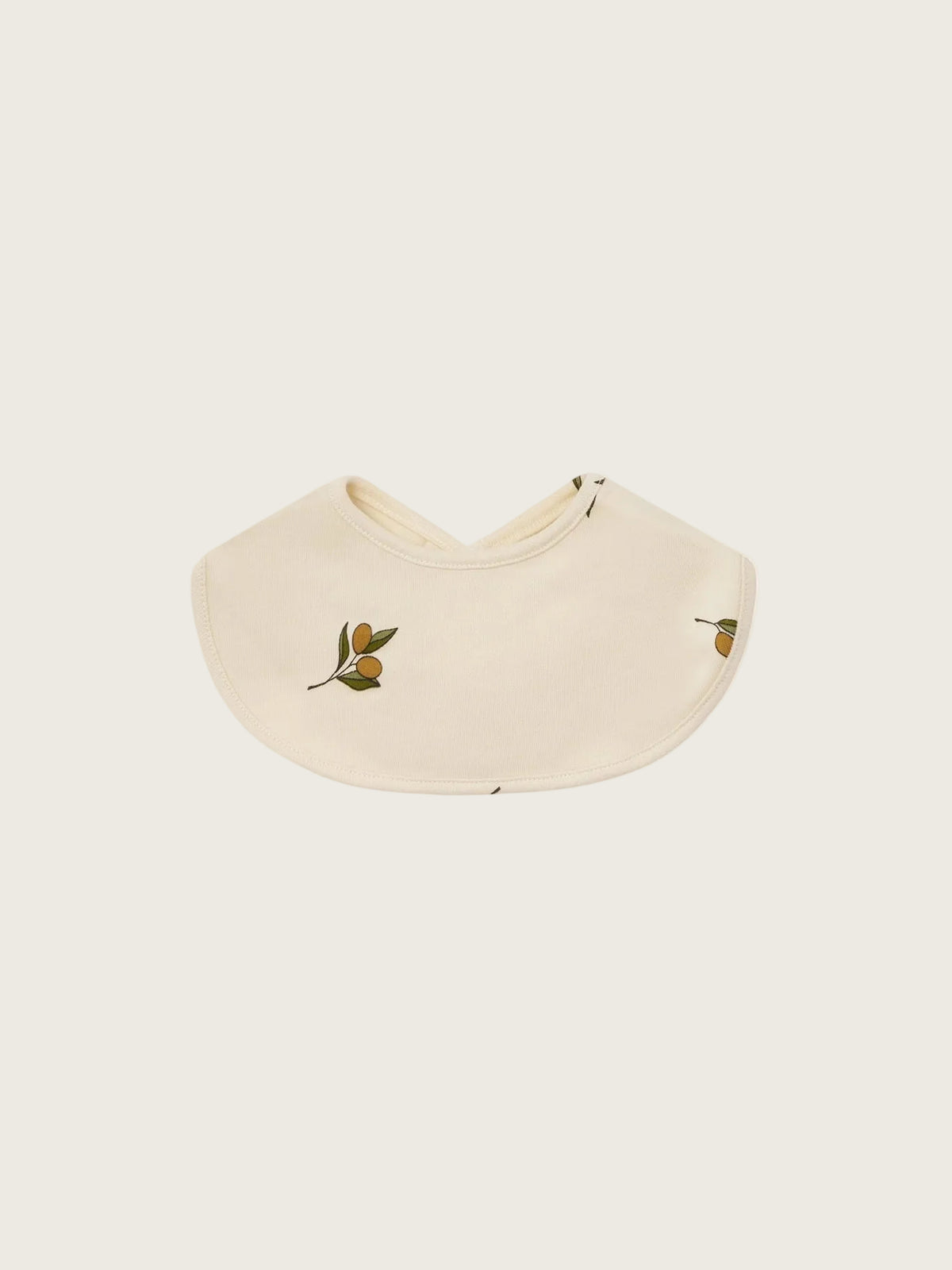 Beige bib with green leaf and olive designs on a white background