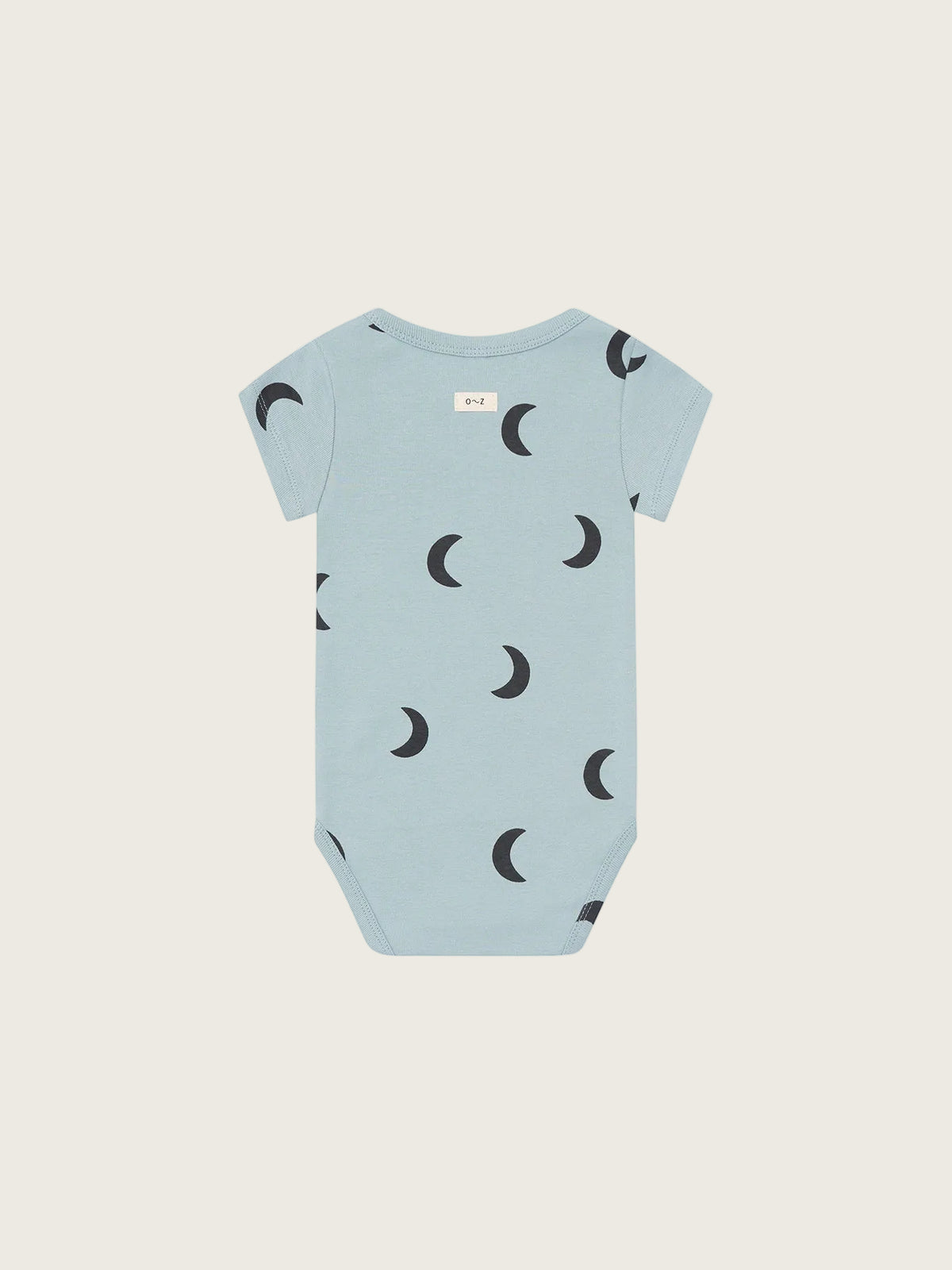 Light blue baby onesie with crescent moon pattern on a white background