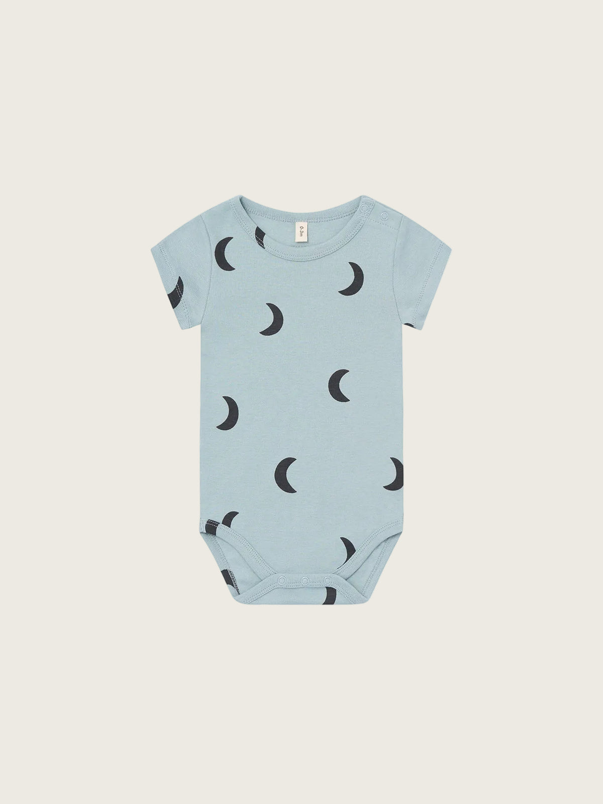 Light blue baby onesie with black moon pattern on a white background