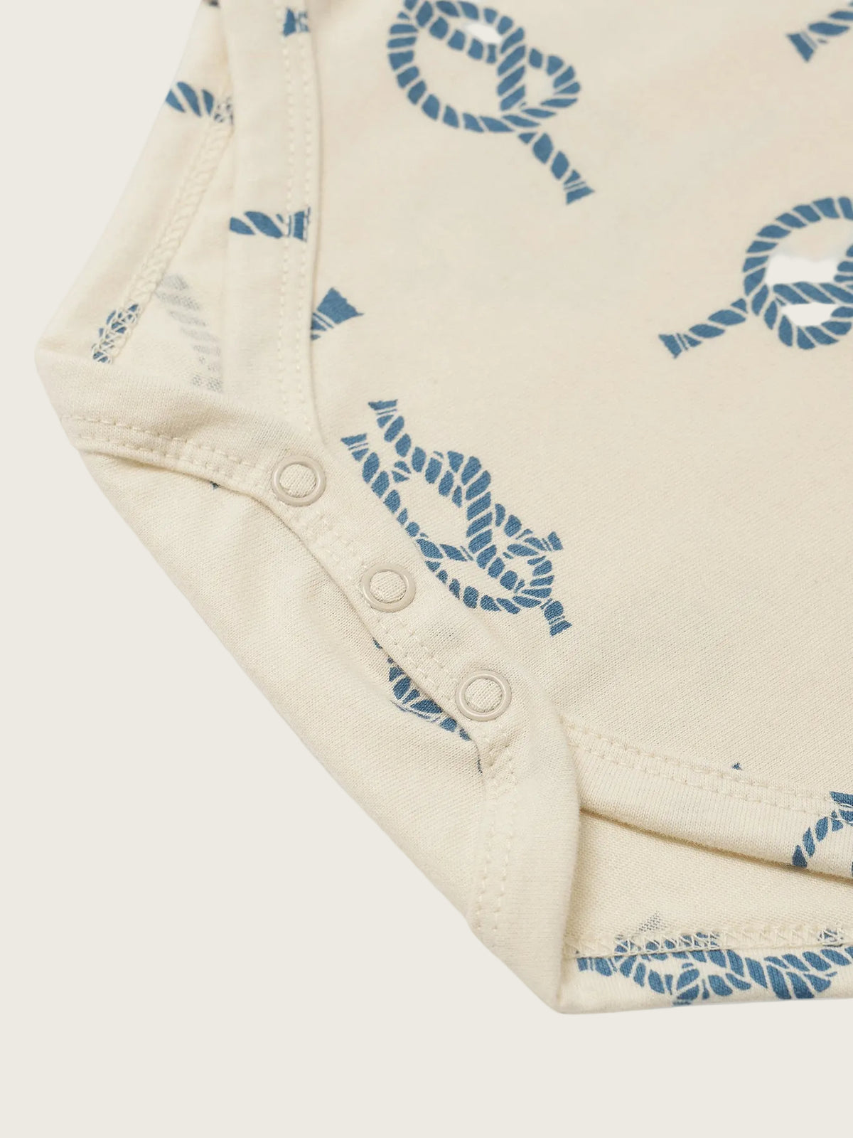 Close-up of a folded piece of fabric with blue patterns on a white background