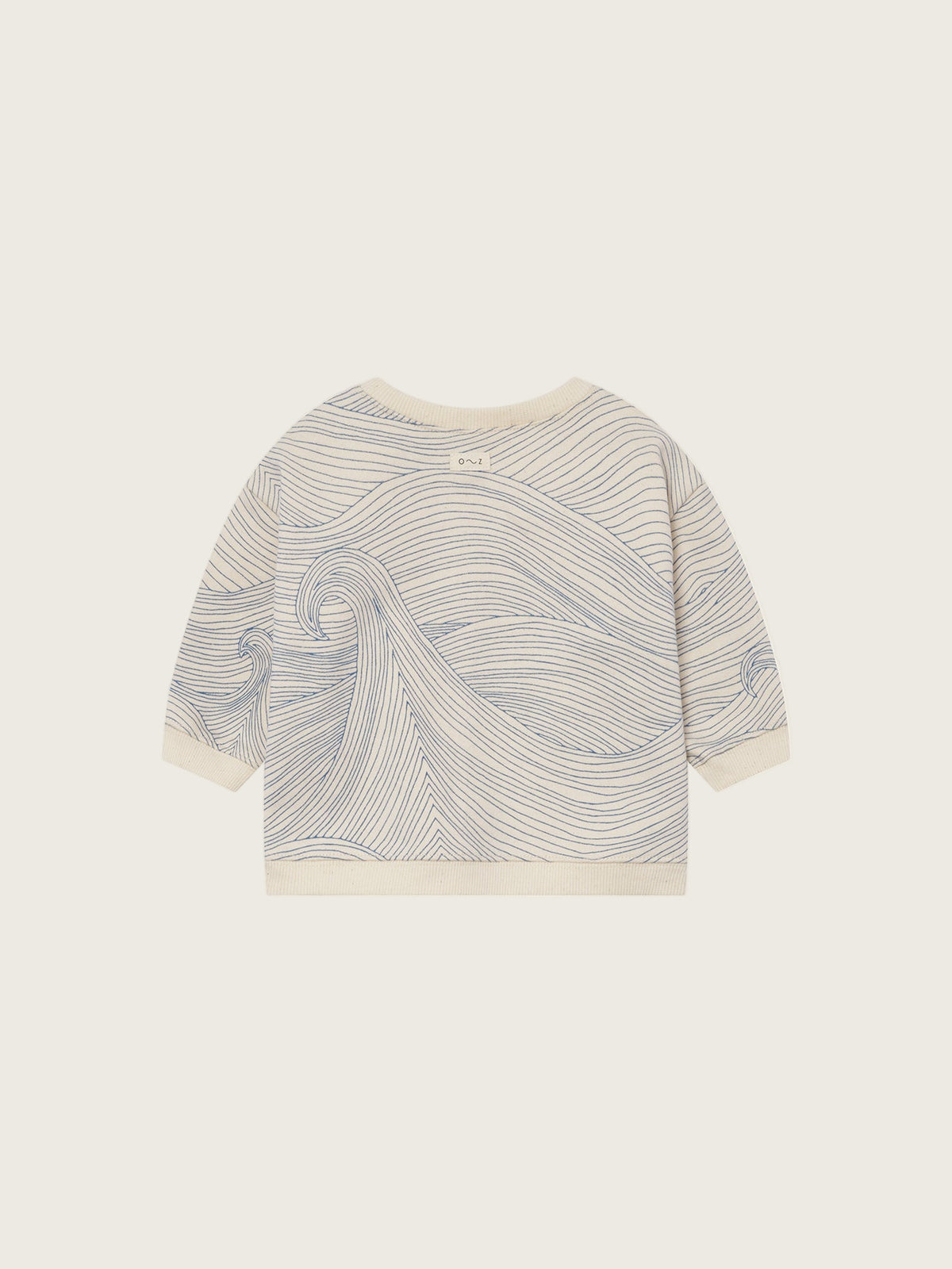 baby cream undyed cotton sweatshirt with shoulder buttons and blue Seascape line-drawn ocean waves
