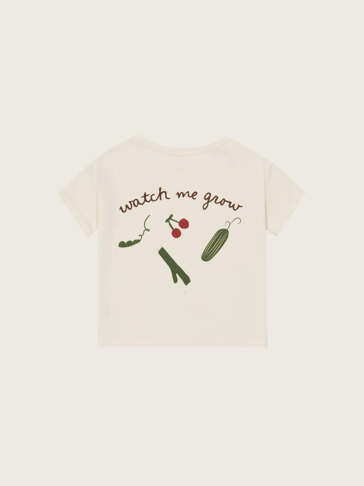 Beige t-shirt with 'watch me grow' text and illustrations on a white background