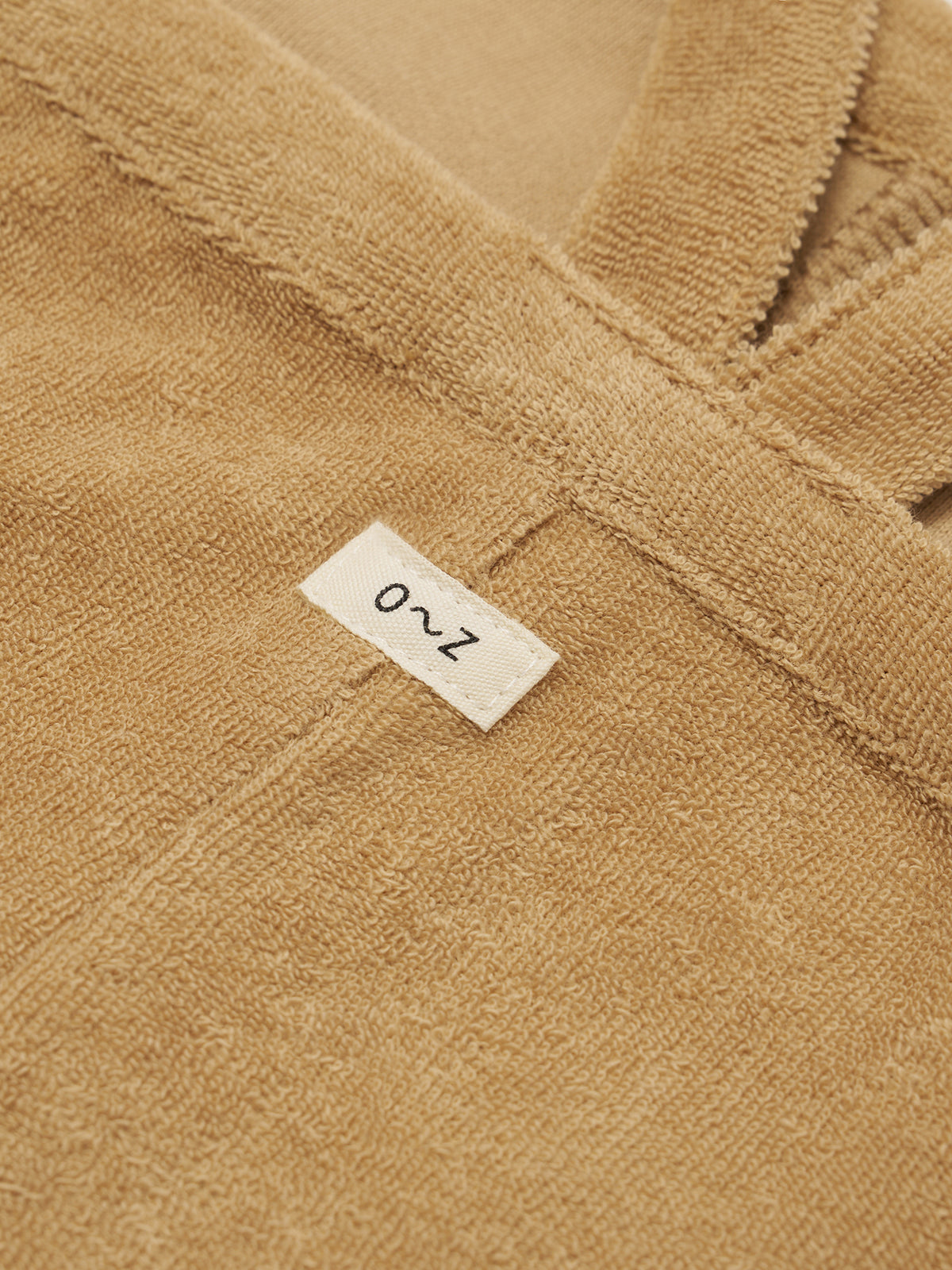 Close-up of a wheat towelling fabric with a label on it
