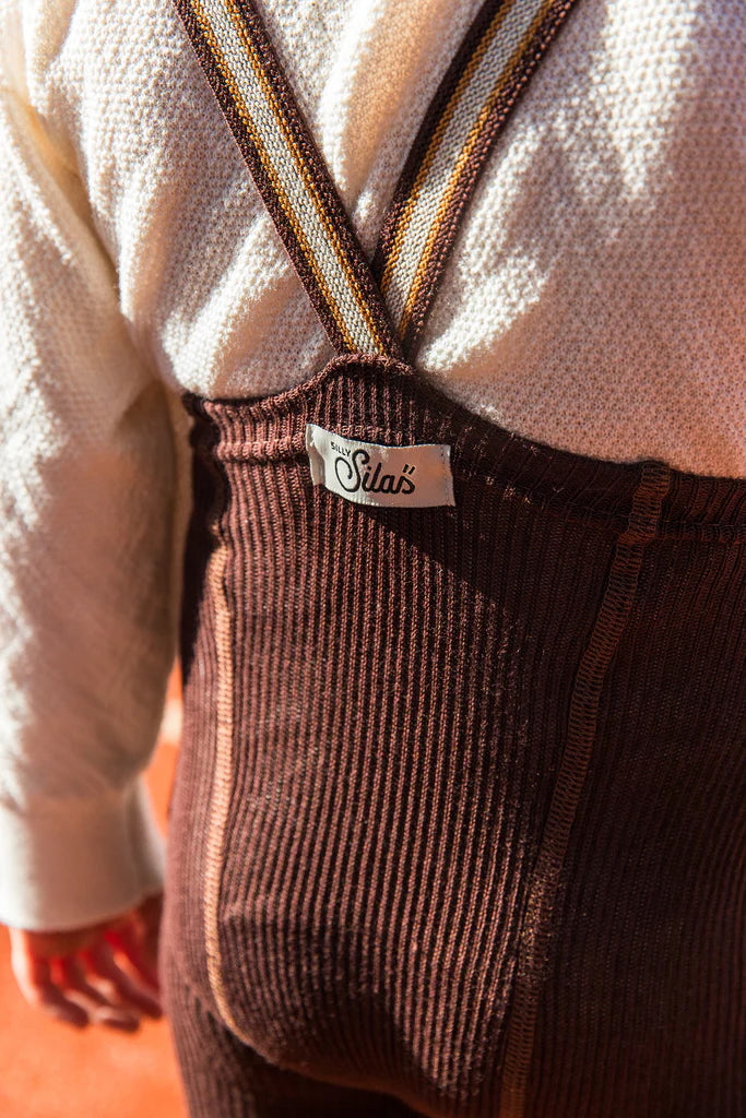 close up of toddler in chocolate ribbed cotton footless tights with striped braces and Silly Silas tag