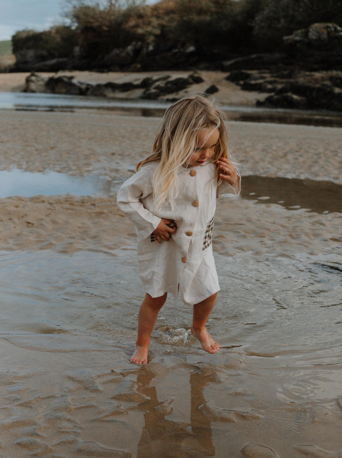 Girl on the beach wearing ceramic white  linien potter dress