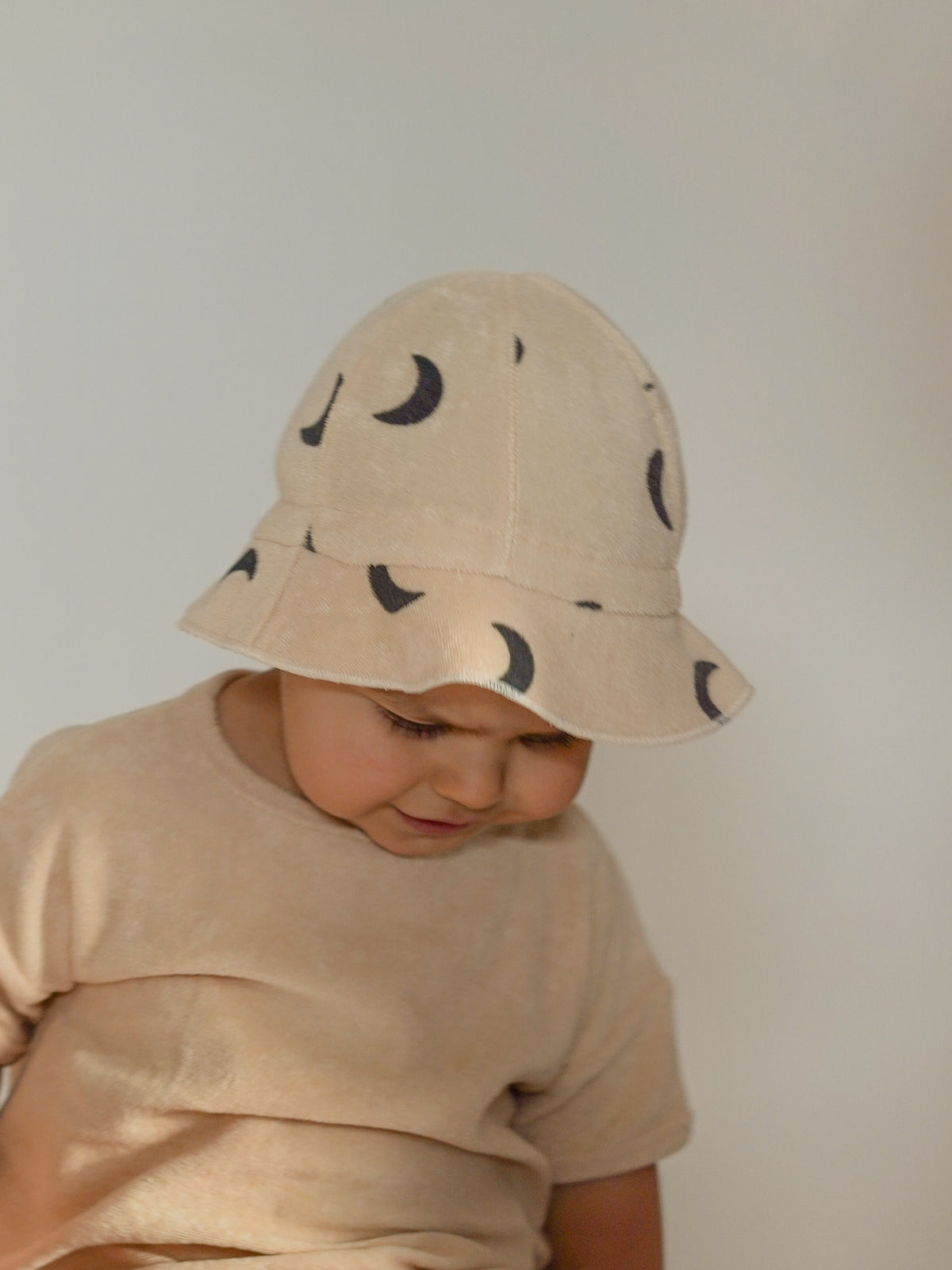 toddler wearing pebble midnight terry sun hat