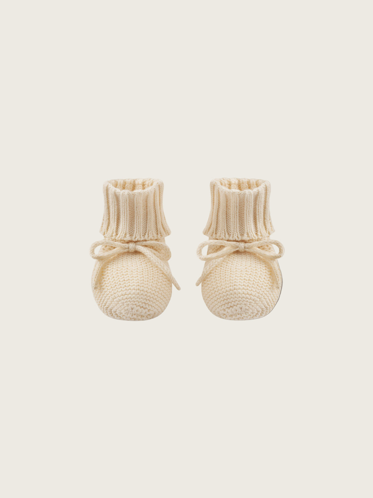baby and toddler undyed cotton knitted booties in cream with ribbons