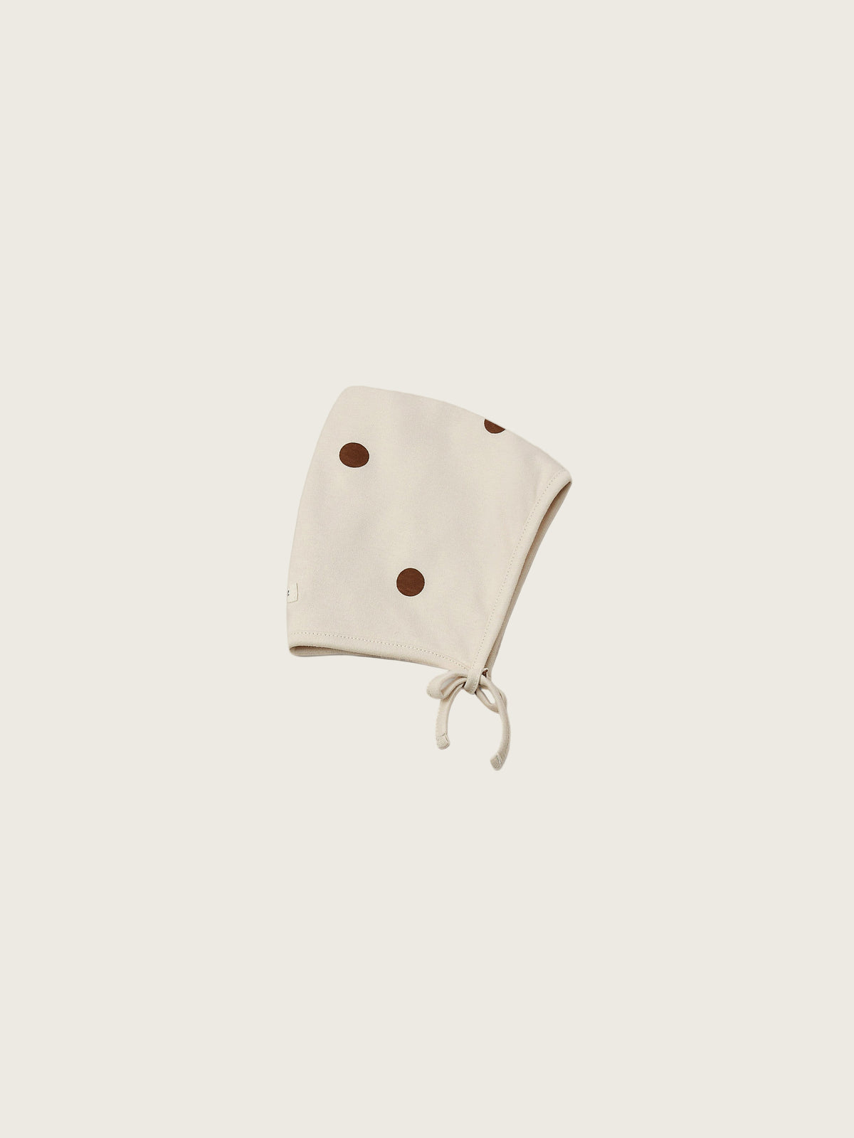 baby and toddler undyed cotton pixie bonnet in cream with brown dots and chin tie