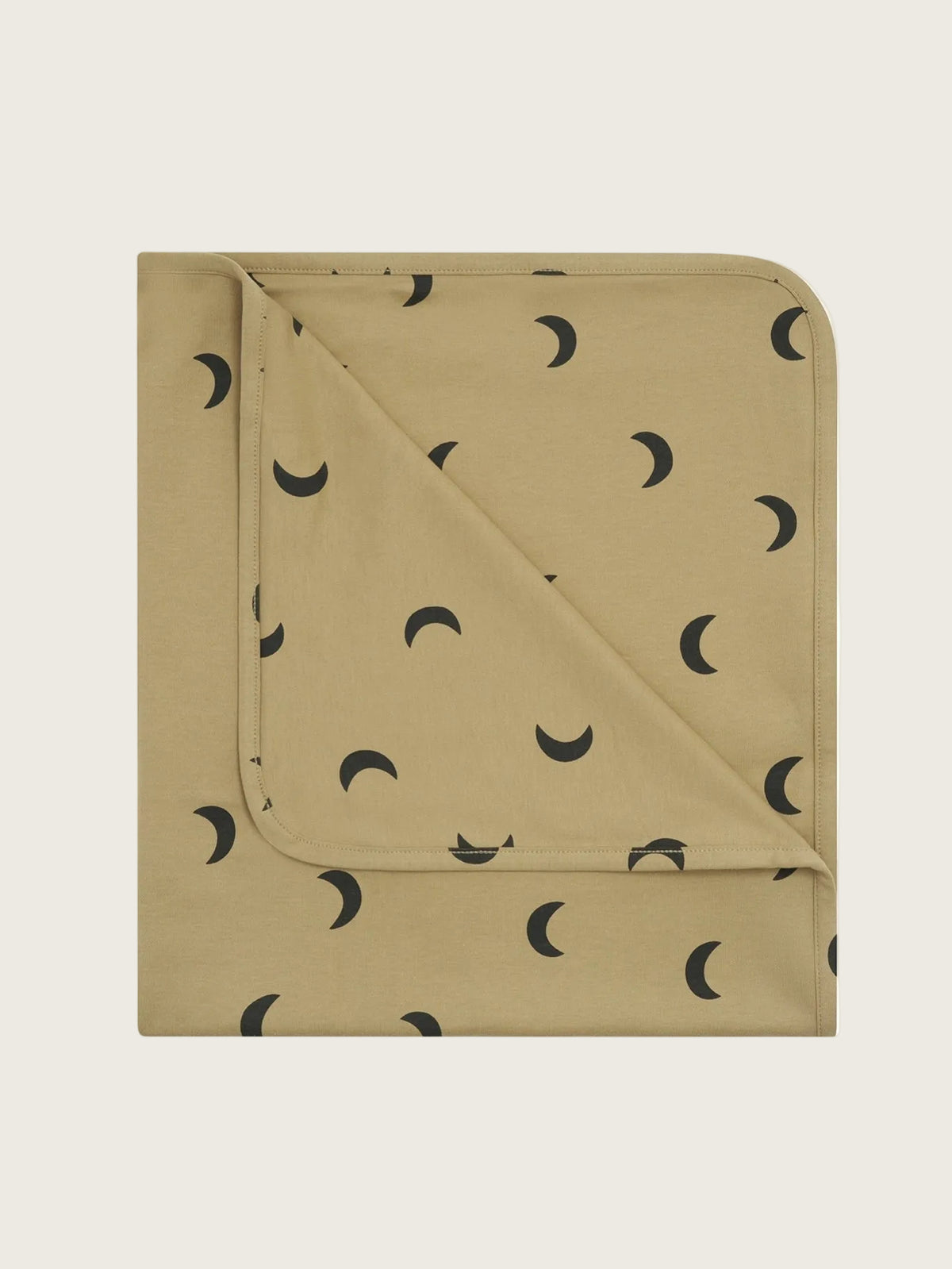 A folded baby blanket in a warm tan color, patterned with small black crescent moon shapes, shown on a plain white background.