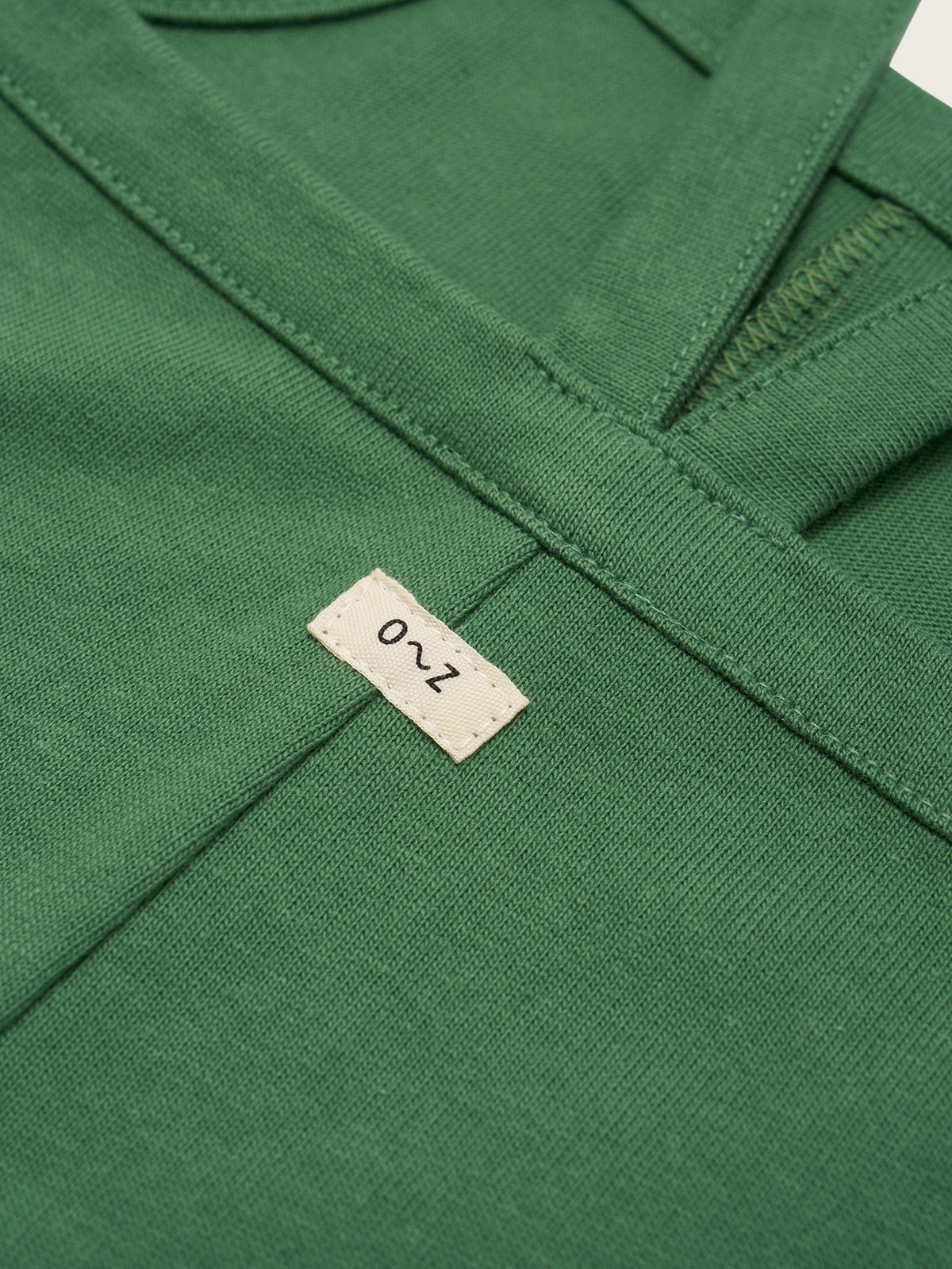 Close-up of a green garment with a brand label on it