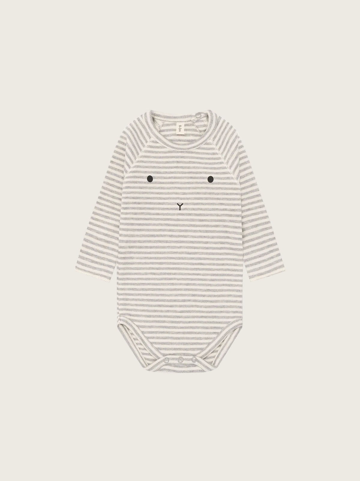 Striped baby bodysuit with a face design on a white background