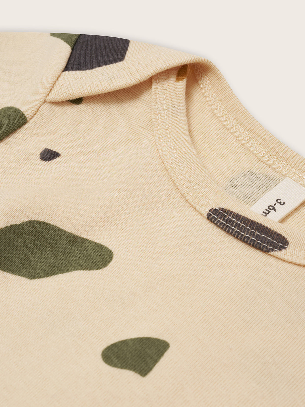 close up of cream ribbed cotton base layer set in terrazzo print with long-sleeved top & leggings