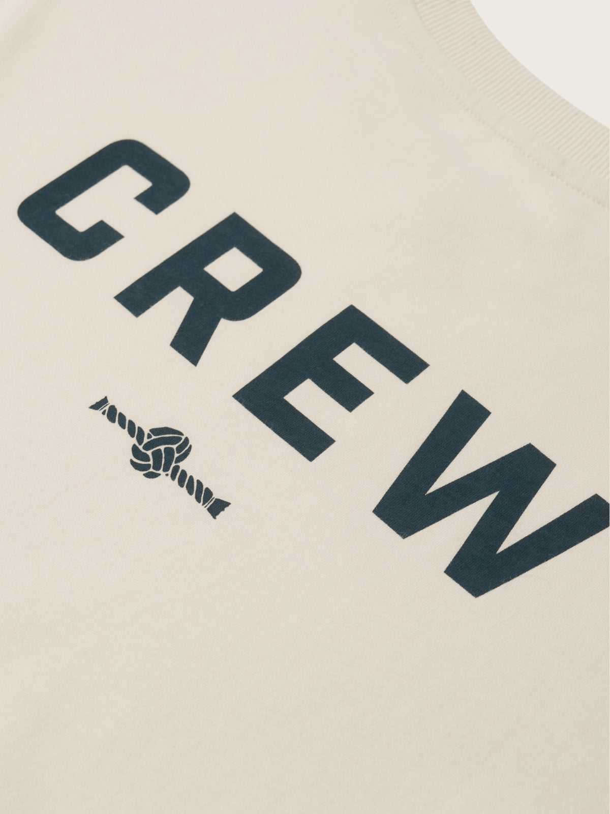 Text 'CREW' with a knot design on a beige background